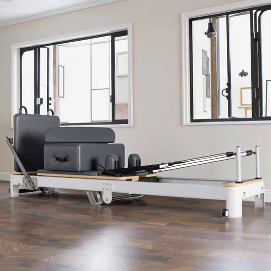 Pilates reformer machine in a room with large windows